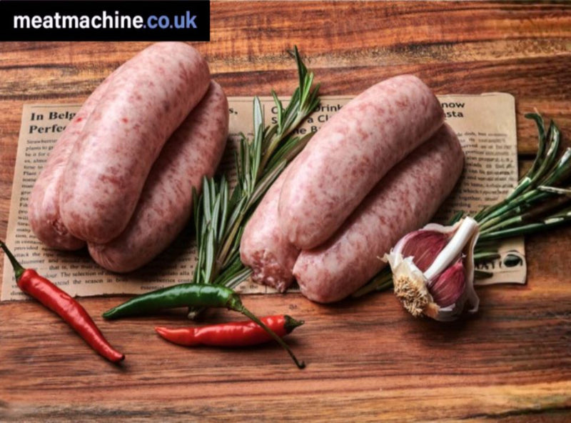 Raw sausages on a wooden board with herbs and peppers, featuring the Meatmachine.co.uk logo.