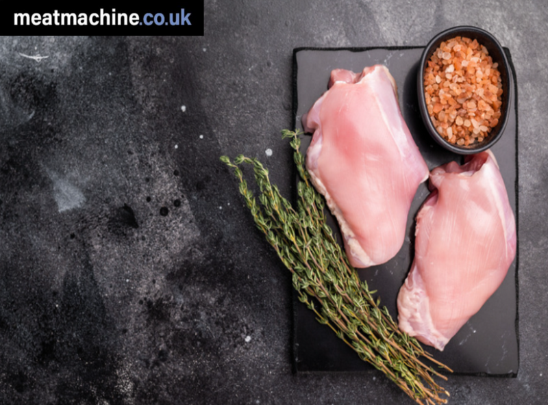 Fresh boneless skinless chicken thigh meat on tray for cooking, Bristol butcher.
