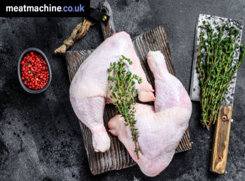 Fresh raw British chicken legs arranged on a board ready for cooking.
