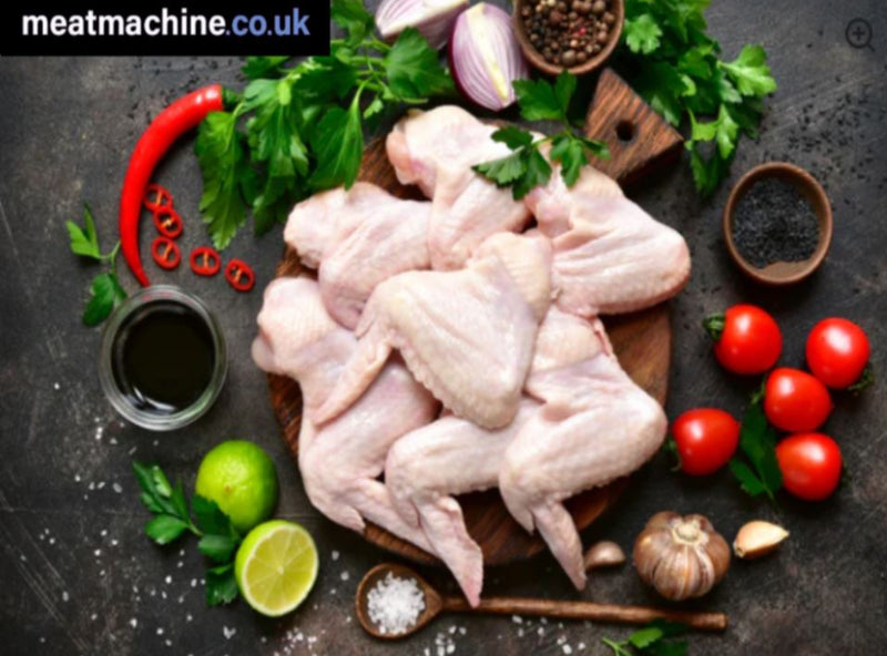 Fresh raw British chicken wings arranged on a board ready for cooking.
